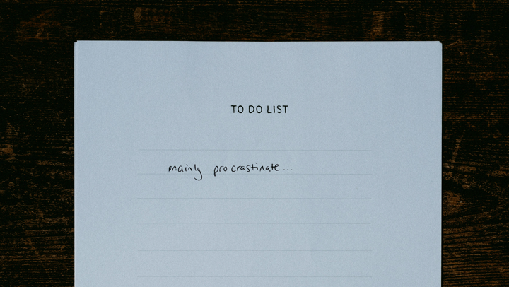 piece of paper showing a to-do list with ‘procrastinate’ written, highlighting the struggle with productivity and pressure to build